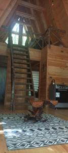 a living room with a spiral staircase in a cabin at Casa Aurora in Puerto Fuy