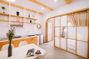 a kitchen and dining room with a table and a window at LaDa's House Da Nang in Danang