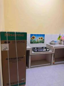 a toy kitchen with a stove and a cardboard box at Hajjah Homestay Jln Rajawali Tg Agas in Muar