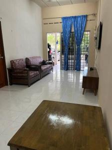 a living room with a couch and a table at Hajjah Homestay Jln Rajawali Tg Agas in Muar