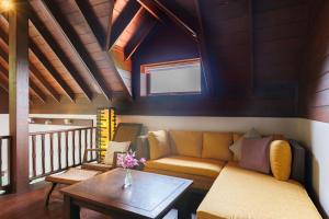 uma sala de estar com um sofá e uma mesa em Baan Suay Villa em Salad Beach