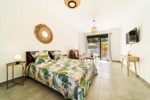 a bedroom with a bed and a living room at Résidence Touristique LES MASCARINS in Petite Île +49 photos