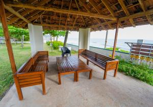 a group of benches sitting under a gazebo at Solaris Varkala Beach Resort By VOYE HOMES in Varkala