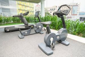 three exercise bikes parked in a gym at Lovina 1811 Harbourbay Residence in Batu Ampar