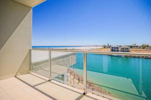 a balcony with a view of a swimming pool and the beach at Wallaroo Marina Apartments in Wallaroo