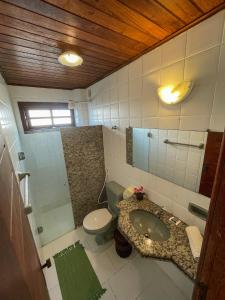 a bathroom with a sink and a toilet at Hotel Porto Dourado - Rede Bem Bahia in Porto Seguro