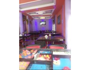 a restaurant with purple walls and tables and a candy bar at Hotel Nanda Lokpal, Ghangaria in Lokpāl