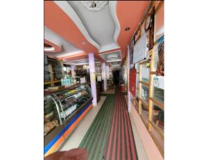 a grocery store aisle with a green and red striped floor at Hotel Nanda Lokpal, Ghangaria in Lokpāl