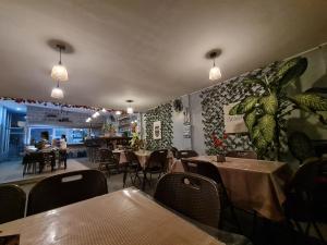 a restaurant with tables and chairs in a room at Hideaways Restobar and Resort 