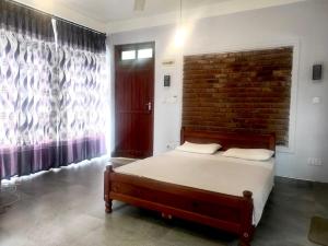 Rúm í herbergi á Kandy Calm Residence (Only for foreigners)