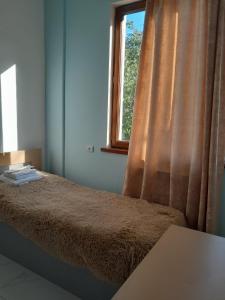 a bedroom with a bed and a window at Hotelvvv888 in Yerevan