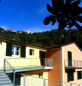 a building with stairs and a hill in the background at Al Molino delle Ghiare in Levanto