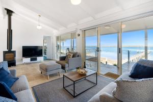 a living room with a view of the ocean at Beladura - 35 Goolwa Channel Drive Hindmarsh Island - Linen Included in Hindmarsh Island