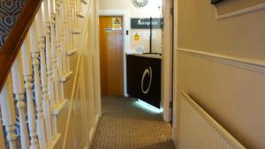 a hallway with a stairway leading to a room at OYO Oban Hotel in Eastbourne