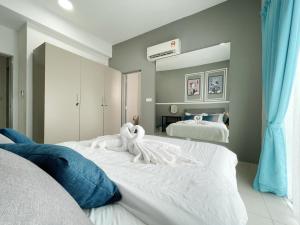 a bedroom with two beds with towels on them at MesaHill Homestay, Nilai by S&T Homez in Nilai