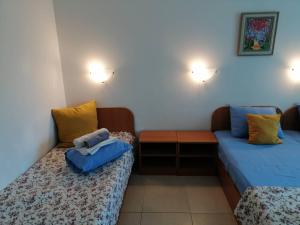 a room with two beds and a couch at Hotel Veronika in Kranevo