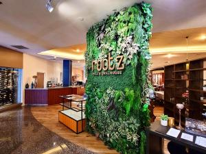 a wall covered in green ivy in a lobby at Guam Plaza Resort in Tumon