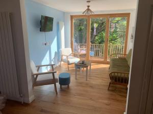 a living room filled with furniture and a large window at Cottage with outstanding views in Velindre