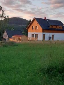 uma casa no meio de um campo de relva em Apartmány Pod Vrchem Kytlice 71 em Kytlice