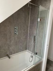 a shower with a glass door in a bathroom at The Lodge at Crown Point, Entire Place, Private Secure Parking, EV Point, Brand new 