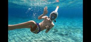 a young man swimming in the water at Nisaki Mathraki B&B in Corfu Town