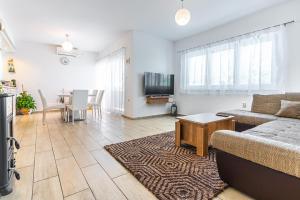 a living room with a couch and a table at Apartments Nina in Maslenica