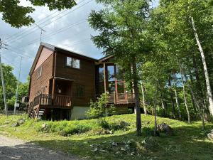 a house on a hill with two decks at Midori House - walking distance to Rusutsu Resort in Rusutsu