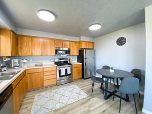 a kitchen with wooden cabinets and a table with a dining room at Madras Oak House in Madras