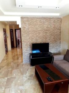 a living room with a couch and a fireplace at 2 minutes from Sheraton Oran. Come and relax here. in Oran