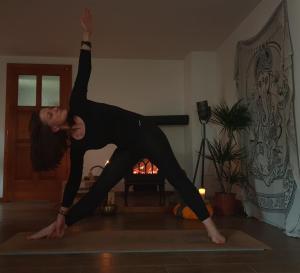 a woman doing a yoga pose in a room at Hand On Heart , ubytování s jógou in Babice