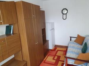 a small room with a bed and a cabinet at Apartament Codruta in Turda