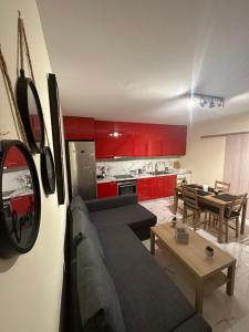 a living room and kitchen with a couch and a table at Red Harmony by the sea Pool and balcony in Kalamata
