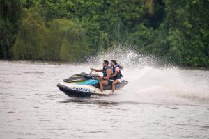 a group of people riding on a jet ski in the water at Kirana - A Santani Villa in Bentota