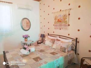 a bedroom with a bed with a quilt on it at Traditional Trikeri Escape House in Ayía Kiriakí