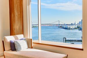 a room with a window with a view of the river at InterContinental Tokyo Bay by IHG in Tokyo
