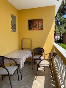 a patio with a table and chairs on a balcony at Apartment Nikolay in Nea Potidaea