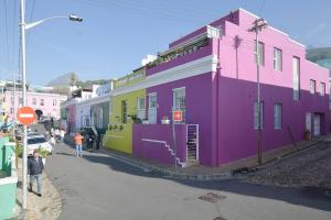a group of colorful buildings on the side of a street at Purple Palace in Historic BoKaap in Cape Town