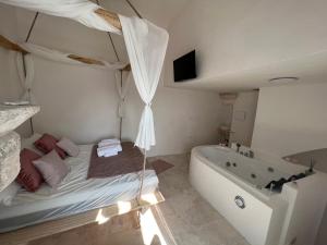 La salle de bains est pourvue d'un lit et d'une baignoire. dans l'établissement Zinzu - by TripOstuni, à Ostuni