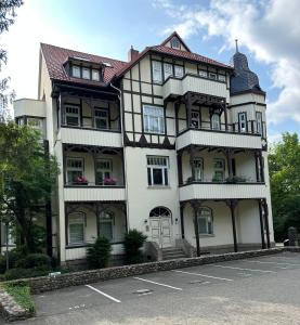 a large white building with a red roof at Spatzennest in Bad Harzburg