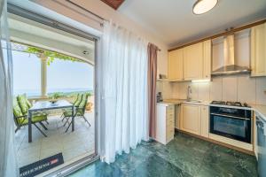 a kitchen with a view of a table at Holiday Home Ivana in Selca