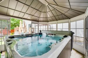 a large hot tub in a room with windows at Pocono Summit Home with Game Room, 3 Mi to Kalahari! in Pocono Summit