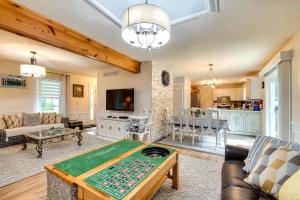 a living room with a poker table and a kitchen at Pocono Summit Home with Game Room, 3 Mi to Kalahari! in Pocono Summit