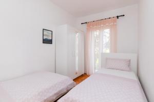 Postel nebo postele na pokoji v ubytování Apartments Martic
