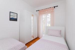 Postel nebo postele na pokoji v ubytování Apartments Martic
