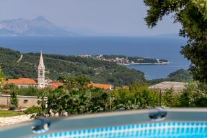 a view of a town with a church and the water at Holiday Home Ivana in Selca