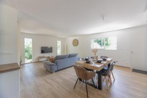 uma sala de estar com uma mesa e um sofá em Villa Graveyron - Maison avec piscine privée em Berrias Et Casteljau