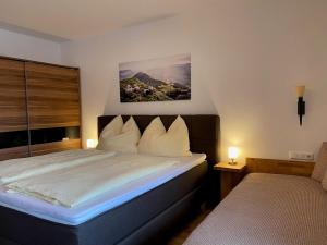 a hotel room with a bed with white pillows at Appartement Maria in Westendorf