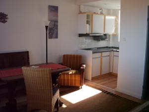 a living room with a table and a kitchen at Tief 10 Wohnung 408 in Wangerland +41 photos