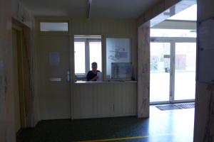 a woman sitting at a counter in a room at Tief 10 Wohnung 408 in Wangerland