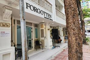 a store front of a building with a sign on it at Forgotten Hostel Silom in Bang Rak